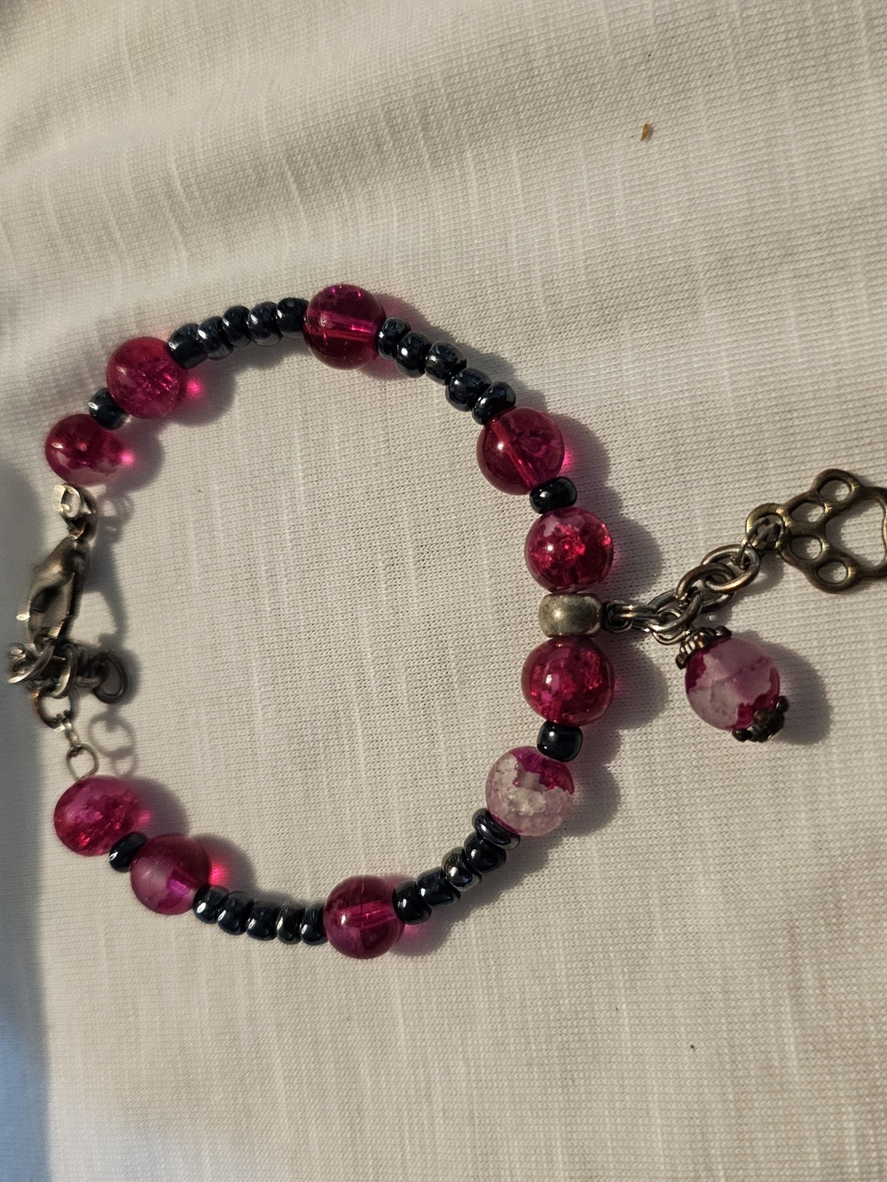 Bright Pink Beaded Bracelet with Dark Accent Beads With Paw Charm